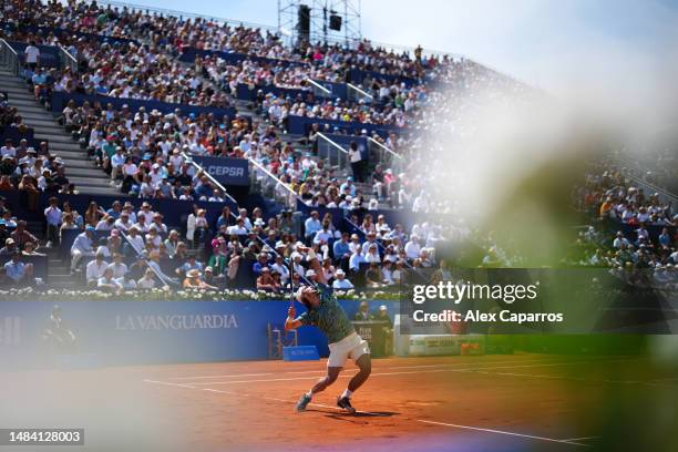 Lorenzo Musetti of Italy serves against Stefanos Tsitsipas of Greece during the semi-final match on day six of the Barcelona Open Banc Sabadell 2023...