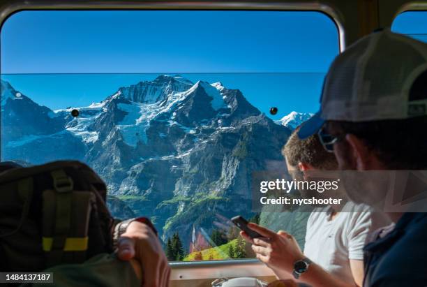 switzerland travel - train to murren with view of jungfrau mountain region - lauterbrunnen stock pictures, royalty-free photos & images