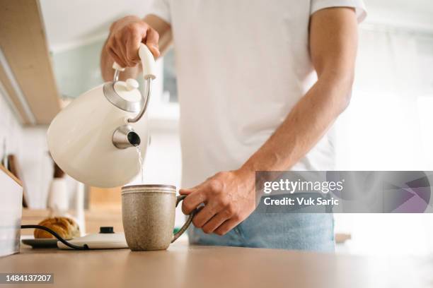 pouring hot water into a cup - boiling water stock pictures, royalty-free photos & images