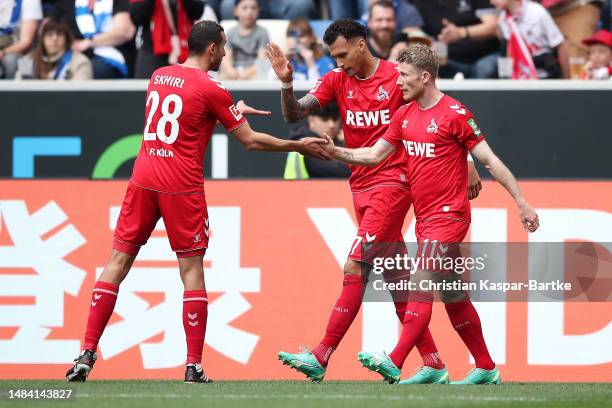 Davie Selke of 1.FC Koeln celebrates with teammates Ellyes Skhiri and Florian Kainz after scoring the team's second goal during the Bundesliga match...