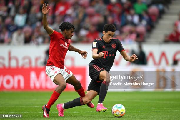 Leandro Barreiro of 1.FSV Mainz 05 battles for possession with Jamal Musiala of FC Bayern Munich during the Bundesliga match between 1. FSV Mainz 05...