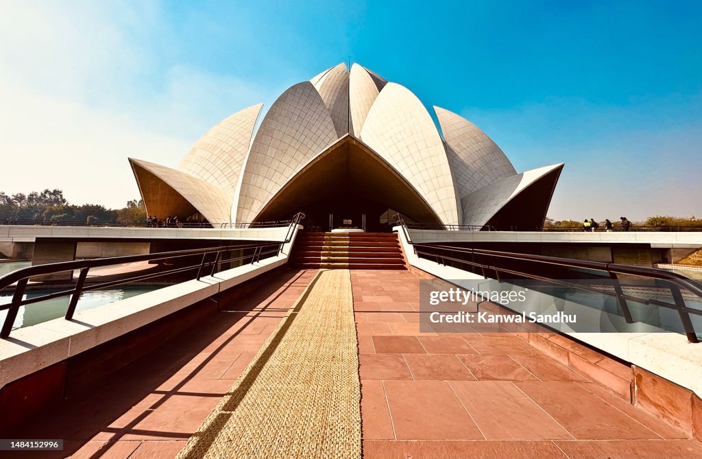 Lotus Temple in delhi on a clear blue sky day with no people in foreground