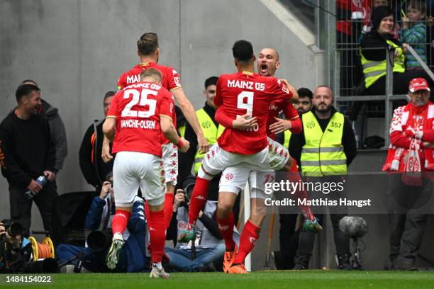 Ludovic Ajorque of 1.FSV Mainz 05 celebrates with teammates after scoring the team's first goal during the Bundesliga match between 1. FSV Mainz 05...