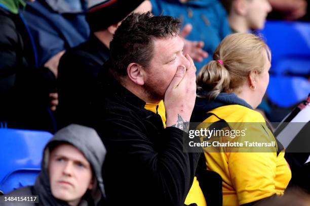 Rochdale fan looks dejected after Isaac Olaofe of Stockport County scores their sides first goal during the Sky Bet League Two between Stockport...