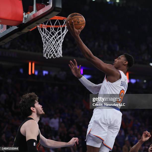 New York Knicks guard RJ Barrett drives on Cleveland Cavaliers forward Cedi Osman during Game Three of the Eastern Conference First Round Playoffs at...