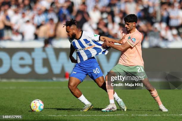 Chidera Ejuke of Hertha Berlin is challenged by Eren Dinkci of SV Werder Bremen during the Bundesliga match between Hertha BSC and SV Werder Bremen...