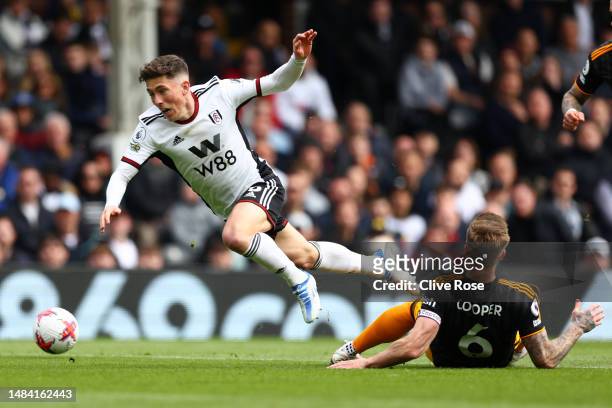 Harry Wilson of Fulham is challenged by Liam Cooper of Leeds United during the Premier League match between Fulham FC and Leeds United at Craven...