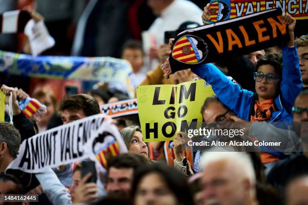 Valencia CF fan is seen holding up a protest sign against the club owner during the LaLiga Santander match between Valencia CF and Sevilla FC at...