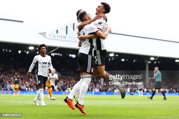 Andreas Pereira of Fulham celebrates with teammates Bobby Reid and Antonee Robinson after scoring the team's second goal during the Premier League...