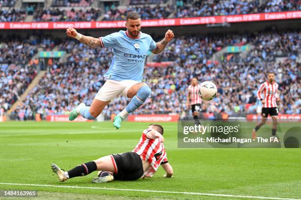 Kyle Walker of Manchester City is challenged by John Fleck of Sheffield United during the FA Cup Semi Final match between Manchester City and...