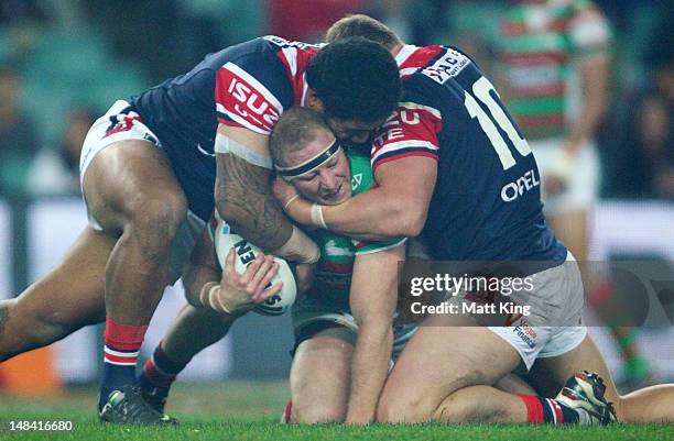 Michael Crocker of the Rabbitohs is tackled during the round 19 NRL match between the Sydney Roosters and the South Sydney Rabbitohs at Allianz...