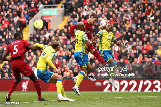 Darwin Nunez of Liverpool jumps for the ball with Andre Ayew and Danilo of Nottingham Forest during the Premier League match between Liverpool FC and...