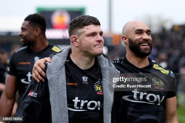 Dave Ewers of Exeter Chiefs is embraced by teammate Olly Woodburn as players of Exeter Chiefs parade the pitch after defeating Bristol Bears during...