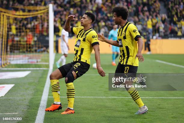 Jude Bellingham of Borussia Dortmund celebrates with teammate Karim Adeyemi after scoring the team's first goal during the Bundesliga match between...