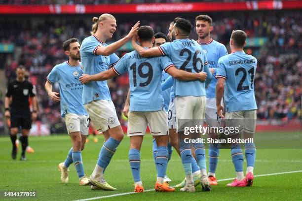 Riyad Mahrez of Manchester City celebrates with teammates after scoring the team's third goal and their hat-trick during the FA Cup Semi Final match...