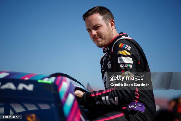 Alex Bowman, driver of the Ally Chevrolet, enters his car during qualifying for the NASCAR Cup Series GEICO 500 at Talladega Superspeedway on April...