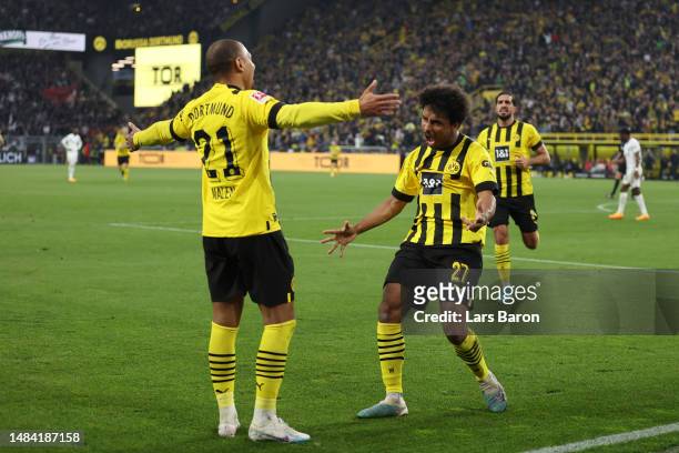 Donyell Malen of Borussia Dortmund celebrates with teammate Karim Adeyemi after scoring the team's fourth goal during the Bundesliga match between...