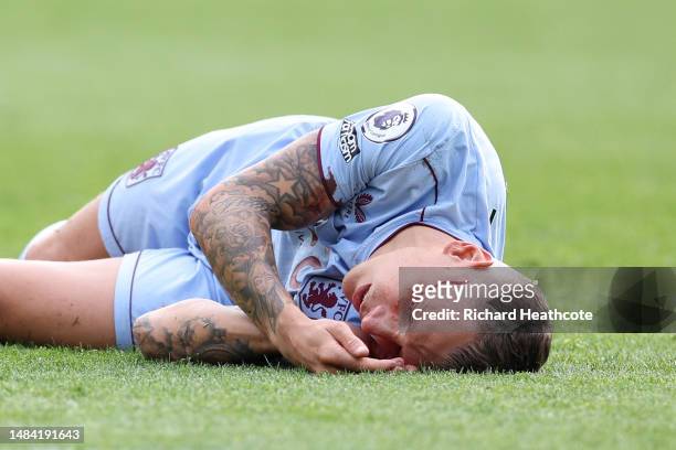 Lucas Digne of Aston Villa lies on the pitch with blood pouring from an injury to his head during the Premier League match between Brentford FC and...