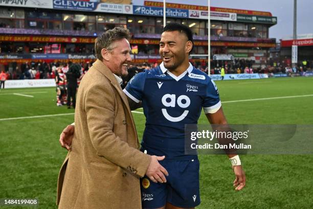 Manu Tuilagi of Sale Sharks embraces Simon Orange, Co-Owner of Sale Sharks following the Gallagher Premiership Rugby match between Gloucester Rugby...