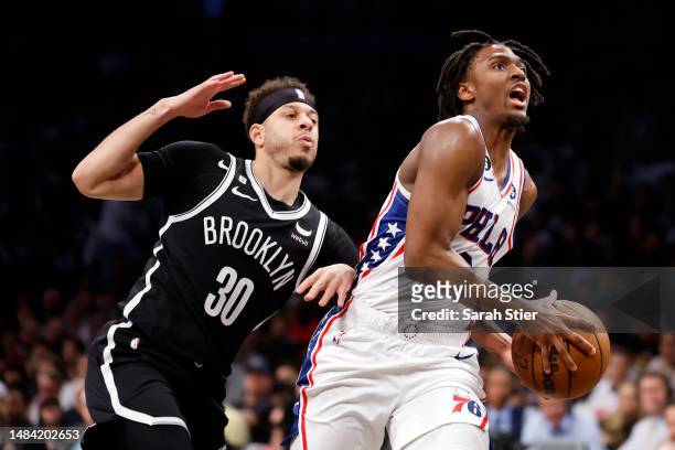 Tyrese Maxey of the Philadelphia 76ers goes to the basket as Seth Curry of the Brooklyn Nets defends during the second half of Game Four of the...