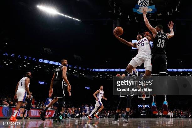 Tyrese Maxey of the Philadelphia 76ers goes to the basket as Nic Claxton of the Brooklyn Nets defends during the second half of Game Four of the...