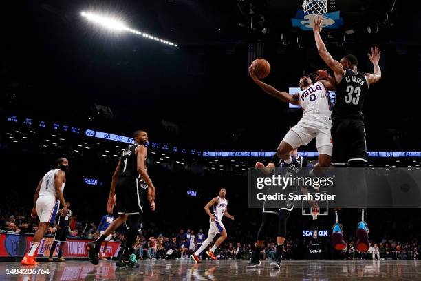 Tyrese Maxey of the Philadelphia 76ers goes to the basket as Nic Claxton of the Brooklyn Nets defends during the second half of Game Four of the...