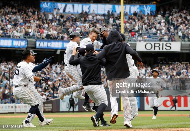 LeMahieu of the New York Yankees is mobbed by teammates after his game winning ninth inning walk off single against the Toronto Blue Jays at Yankee...