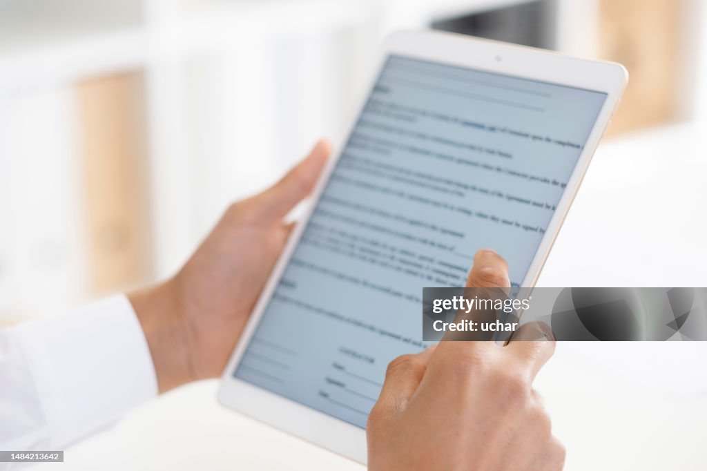 Unrecognizable person is using a digital tablet