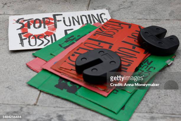Signs sit piled up at an Earth Day gathering titled “End the Era of Fossil Fuels,” at Freedom Plaza on April 22, 2023 in Washington, DC. Activists...