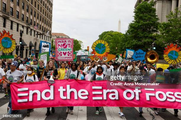 Activists participate in an Earth Day march titled “End the Era of Fossil Fuels,” to the White House on April 22, 2023 in Washington, DC. Activists...