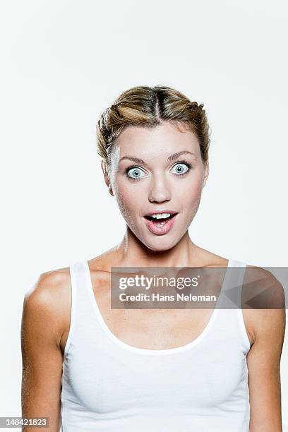 young woman looking surprised - woman vest stock pictures, royalty-free photos & images