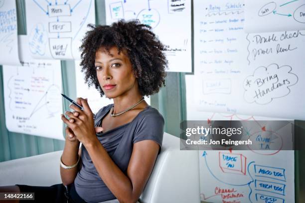 businesswoman seated with charts - content strategy stock pictures, royalty-free photos & images