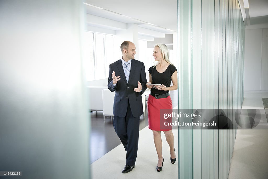 A businessman and businesswoman talking