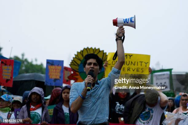 Saad Amer, founder of Justice Environment, speaks during an Earth Day march titled “End the Era of Fossil Fuels,” in Lafayette Park during a...