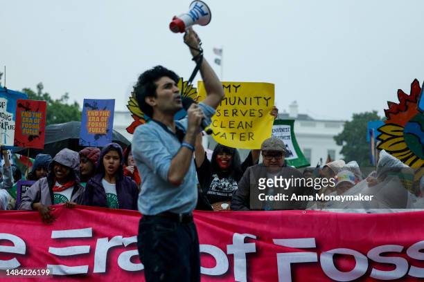 Saad Amer, founder of Justice Environment, speaks during an Earth Day march titled “End the Era of Fossil Fuels,” in Lafayette Park during a...