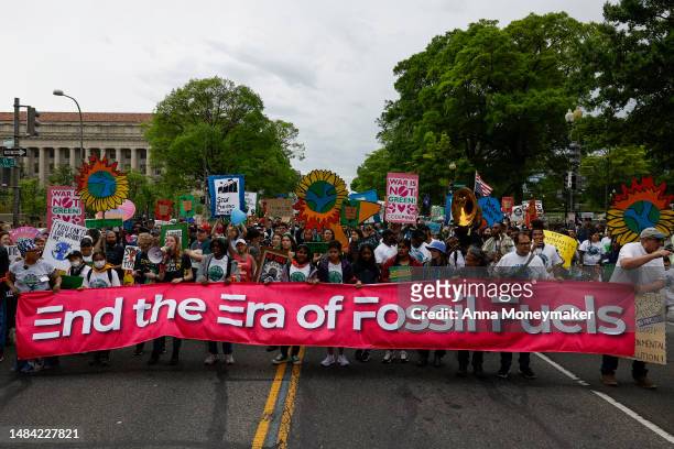 Activists participate in an Earth Day march titled “End the Era of Fossil Fuels,” to the White House on April 22, 2023 in Washington, DC. Activists...