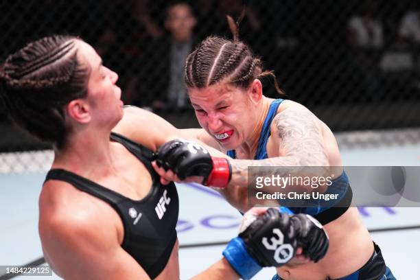 Karol Rosa of Brazil punches Norma Dumont of Brazil in a featherweight fight during the UFC Fight Night event at UFC APEX on April 22, 2023 in Las...
