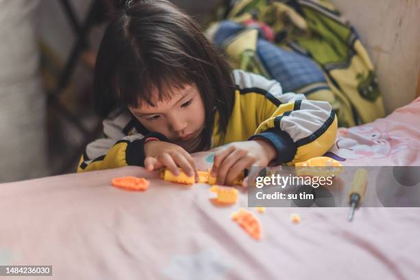 a asian girl is repairing toys - kit bildbanksfoton och bilder