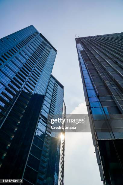 three skyscrapers with blue glass at sudirman street, south jakarta - sudirman stock pictures, royalty-free photos & images