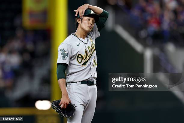 Shintaro Fujinami of the Oakland Athletics reacts after giving up a two-run home run against Adolis Garcia of the Texas Rangers in the bottom of the...