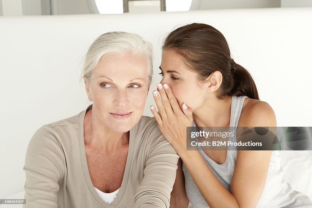 Daughter whispering to her mother