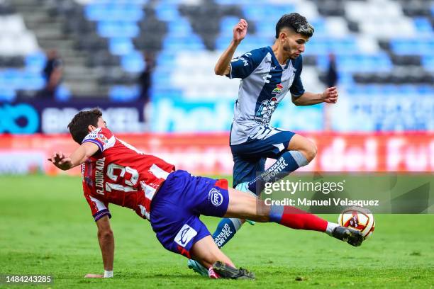 Rodrigo Dourado of Atletico San Luis battles for the ball against Francisco Figueroa of Pachuca during the 16th round match between Pachuca and...