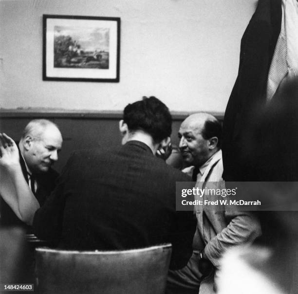 American artist Barnett Newman and art critic Clement Greenberg sit with an unidentified third man at a table in the Cedar Tavern, New York, New...