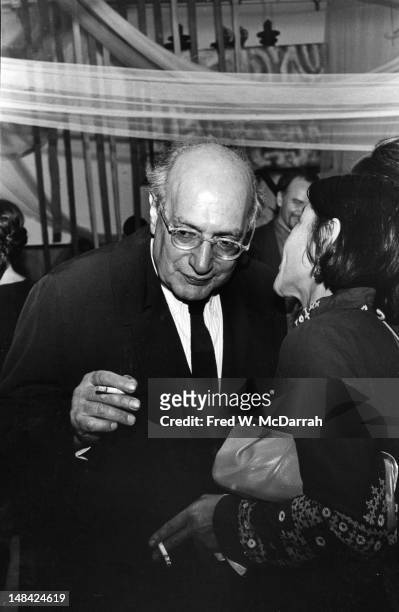 Latvian-born American painter Mark Rothko leans forward to listen to American filmmaker Shirley Clarke as they attend an unspecified event, New York,...