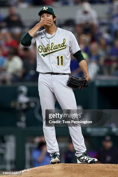Shintaro Fujinami of the Oakland Athletics reacts after giving up a two-run double against Jonah Heim of the Texas Rangers in the bottom of the...