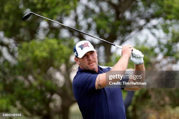 Former NFL player Brian Urlacher tees off on the second hole during the second round of the Invited Celebrity Classic at Las Colinas Country Club on...