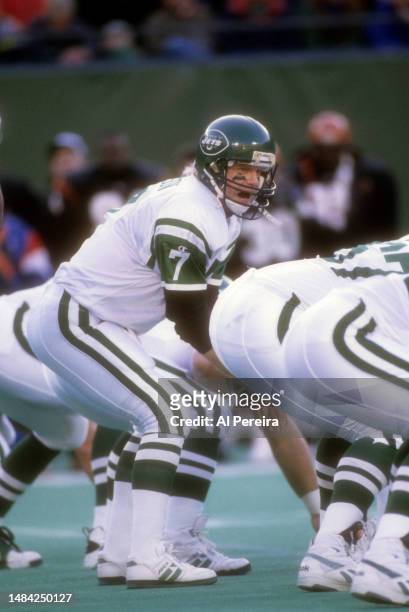 Quarterback Boomer Esiason of the New York Jets calls a play in the game while wearing the "Throwback" retro style uniform between the Cincinnati...
