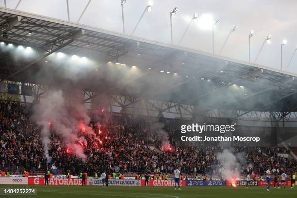 Action is briefly interrupted after a flare was thrown onto the field of play during the UEFA Youth League 2022/23 Semi-Final match between HNK...