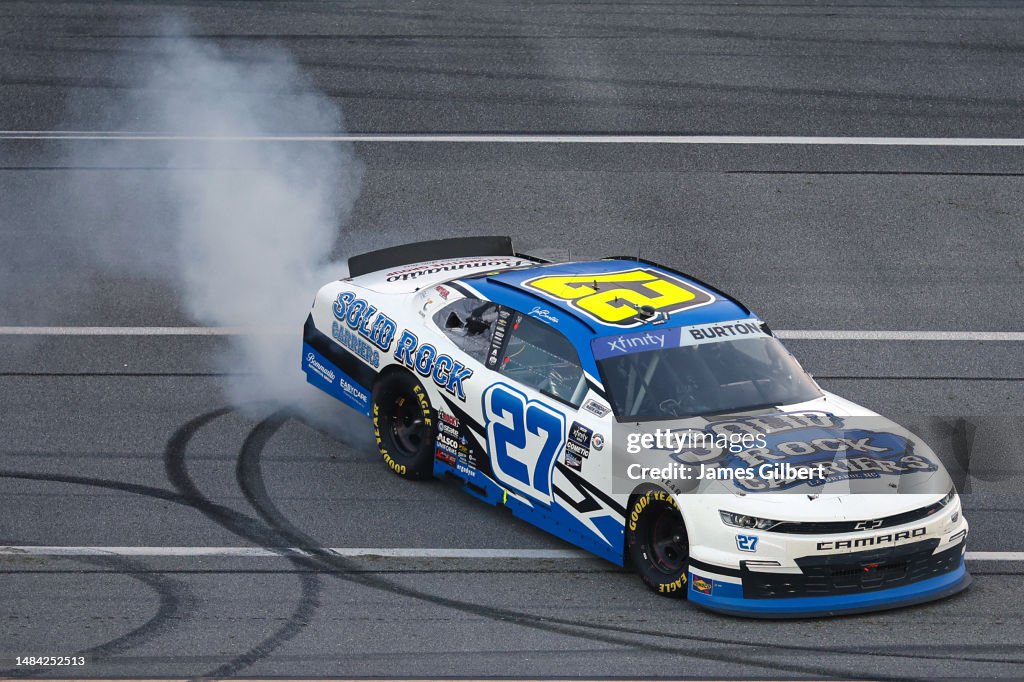 Jeb Rocks Jeb Burton, driver of the Solid Rock Carriers Chevrolet, celebrates ...