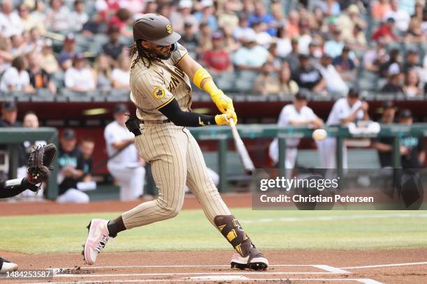 Fernando Tatis Jr. #23 of the San Diego Padres hits a solo home run against the Arizona Diamondbacks during the first inning of the MLB game at Chase...